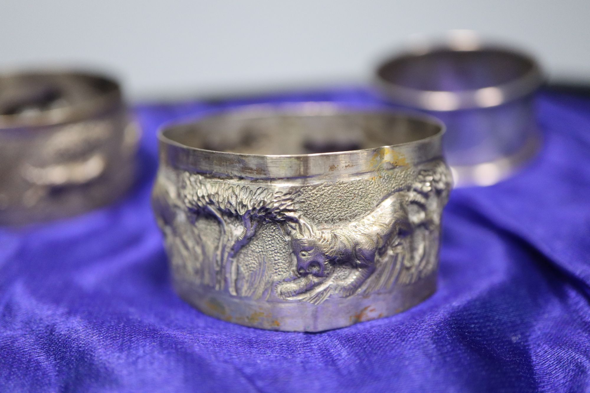 A set of six George V silver Old English and shell pattern teaspoons, other minor cutlery and three white metal napkin rings.